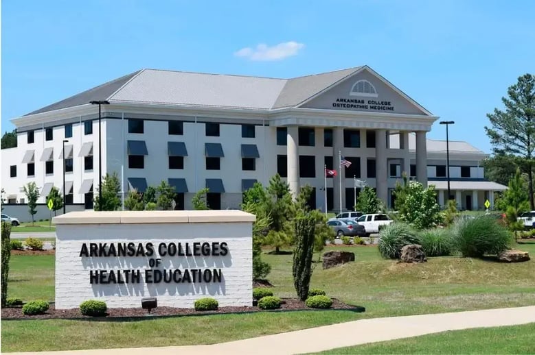 Front view of the Arkansas College of Osteopathic Medicine building with a sign for the medical school in the front.
