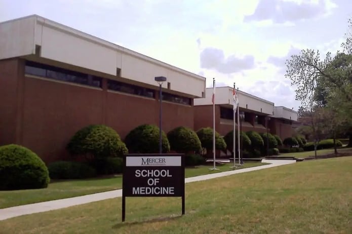 Front side view of the Mercer University School of Medicine building with a sign reading the name of the medical school on the font.