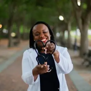 Person in a lab coat holding a stethoscope