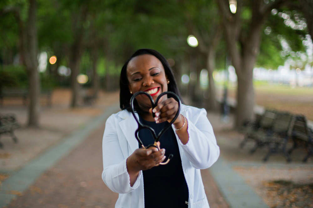 Person in a lab coat holding a stethoscope