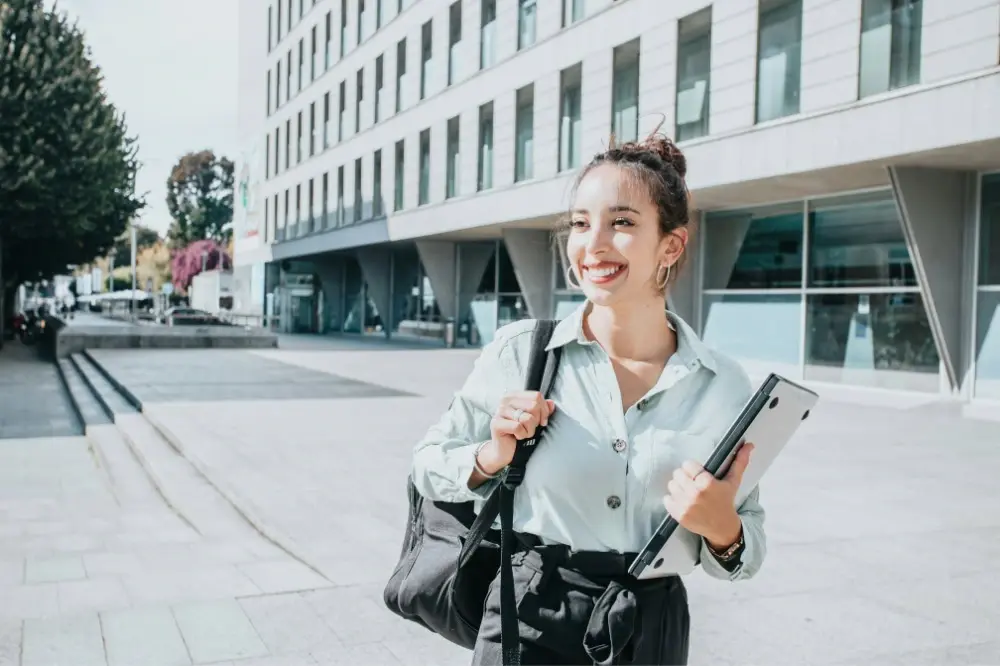 Medical student walking wither a laptop and bag