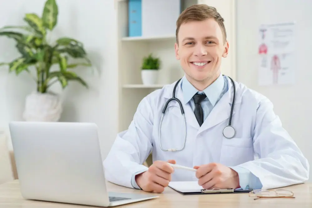 Student Doctor Sitting at a desk with a computer