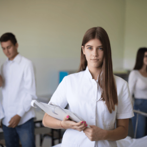 female medical student preparing to take the COMLEX exam, four students in the background