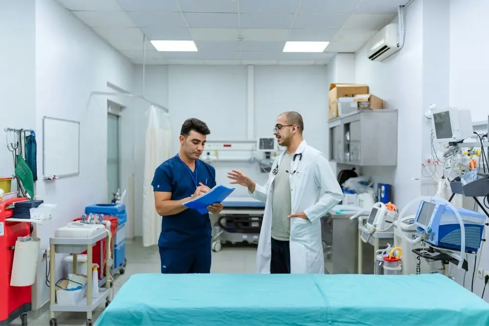 A doctor giving a resident student notes